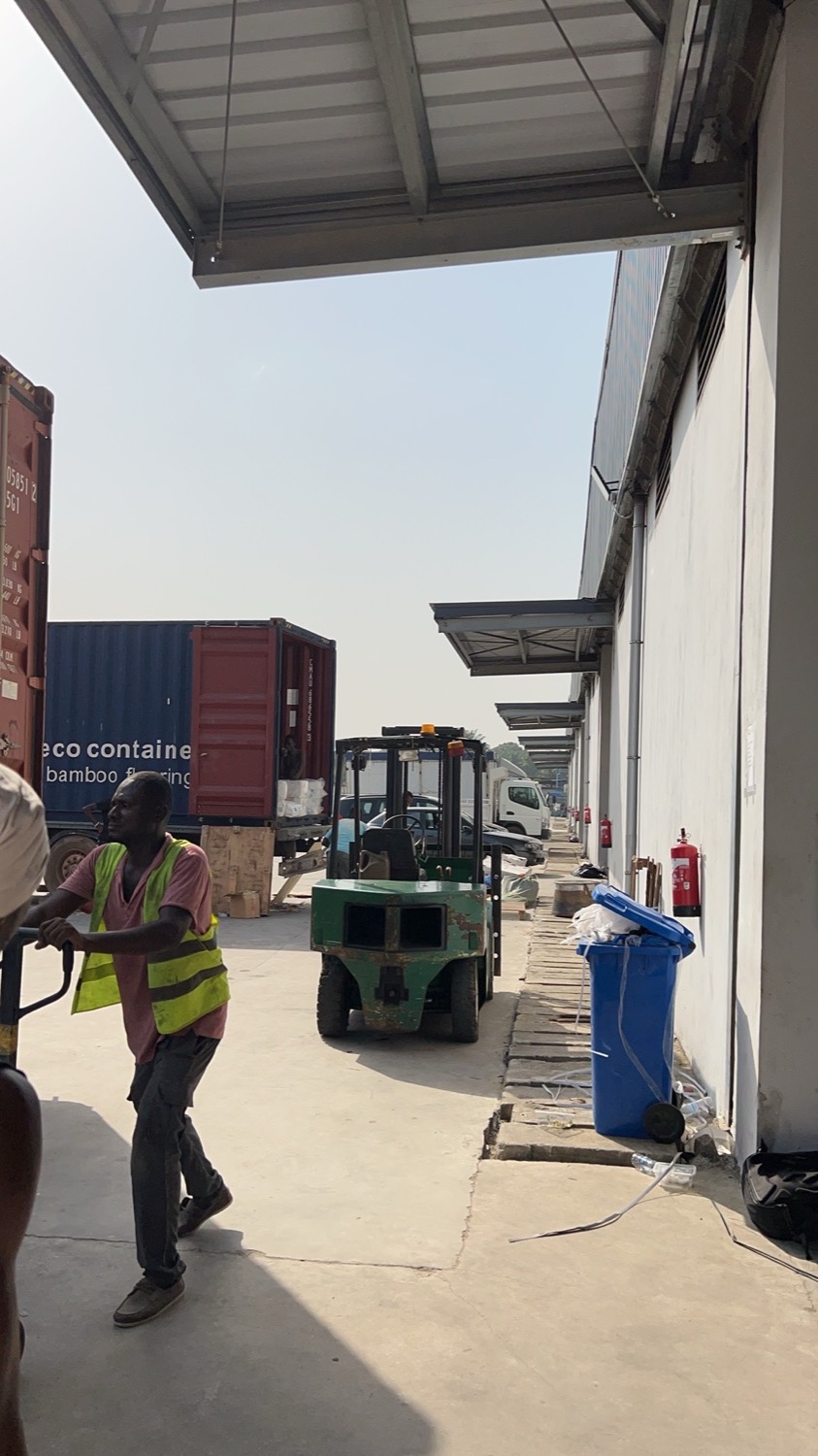 Export warehouse loading dock with containers and forklift