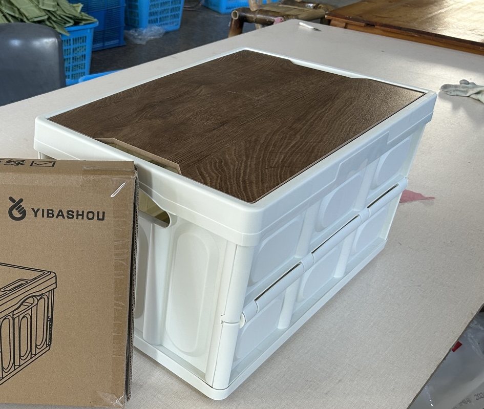 Finished plastic folding storage crate with wooden lid and retail carton